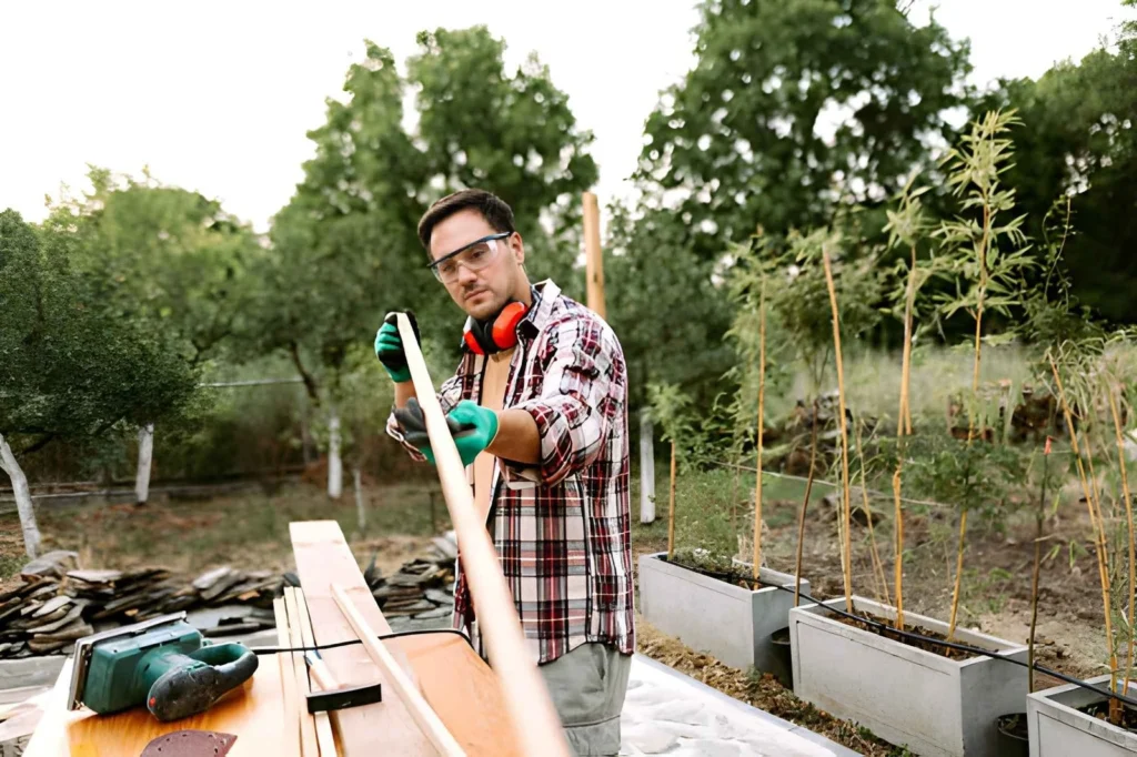 Beginner building a simple wooden garden project for a backyard homestead.