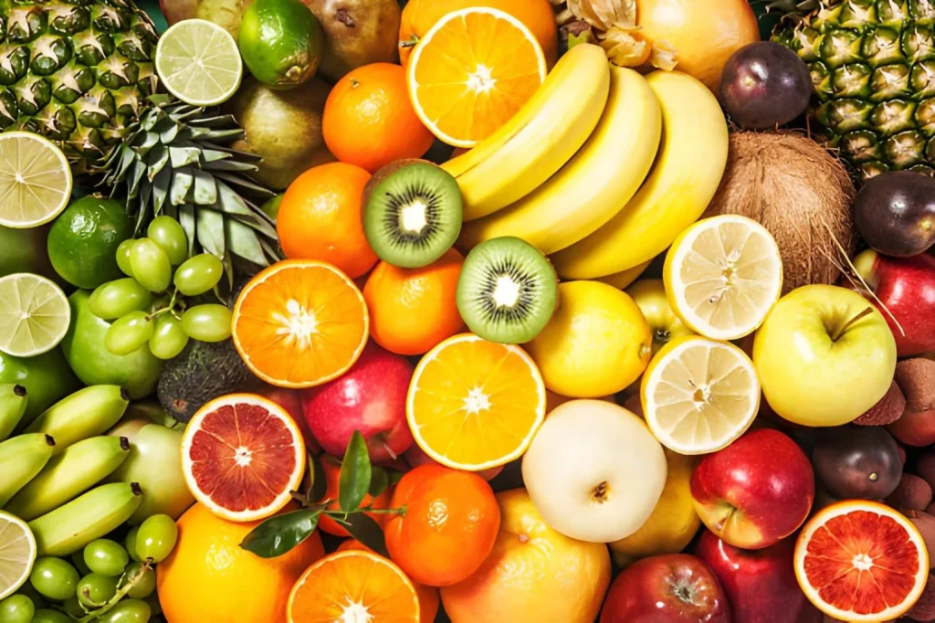 Colorful assortment of fresh apples, bananas, oranges, lemons, grapes, kiwi, pineapple, and other fruits ready to be sliced and dehydrated for beginner food preservation.