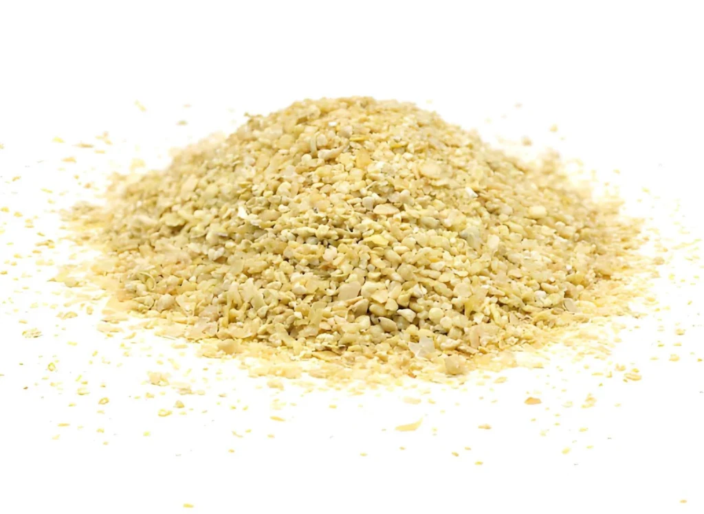 Close-up of soybean meal, showing one of the nitrogen-rich plant-based organic fertilizer types used to feed garden soil.